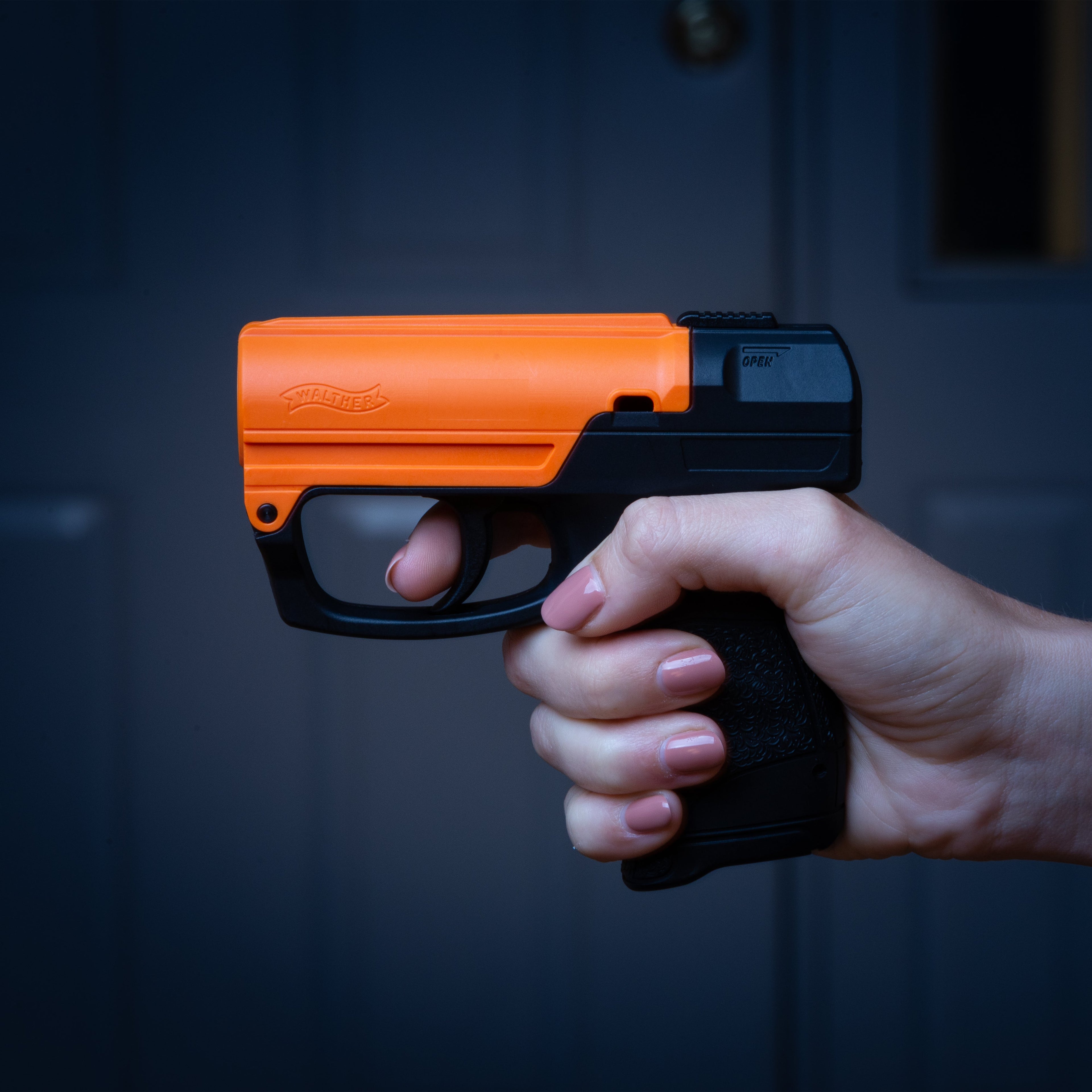 SABRE Aim and Fire Pepper Gel in hand demonstrating grip safety and trigger deployment – easy-aim non-lethal pepper gel pistol for self-defense