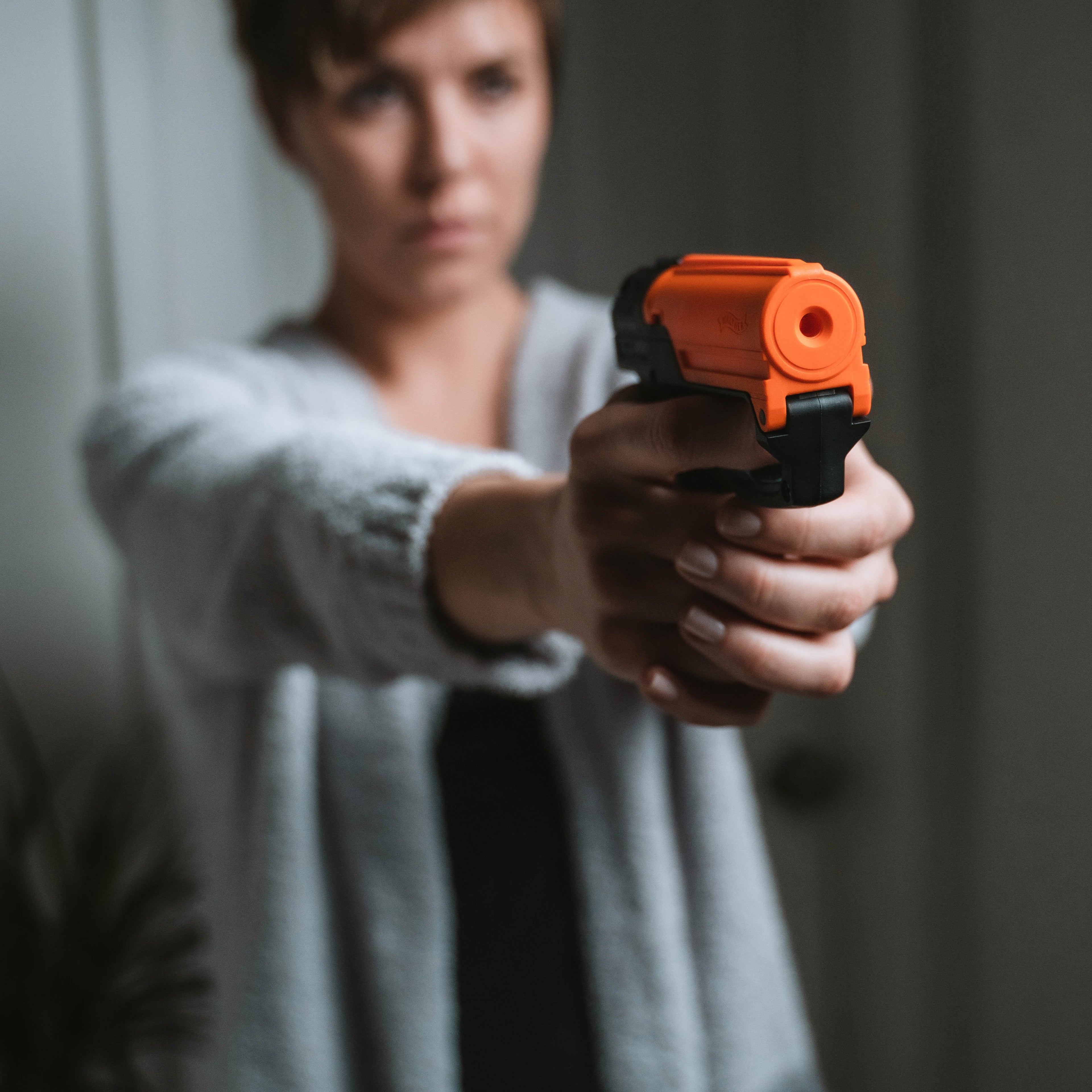 SABRE Aim and Fire Pepper Gel in hand demonstrating grip safety and trigger deployment – easy-aim non-lethal pepper gel pistol for self-defense