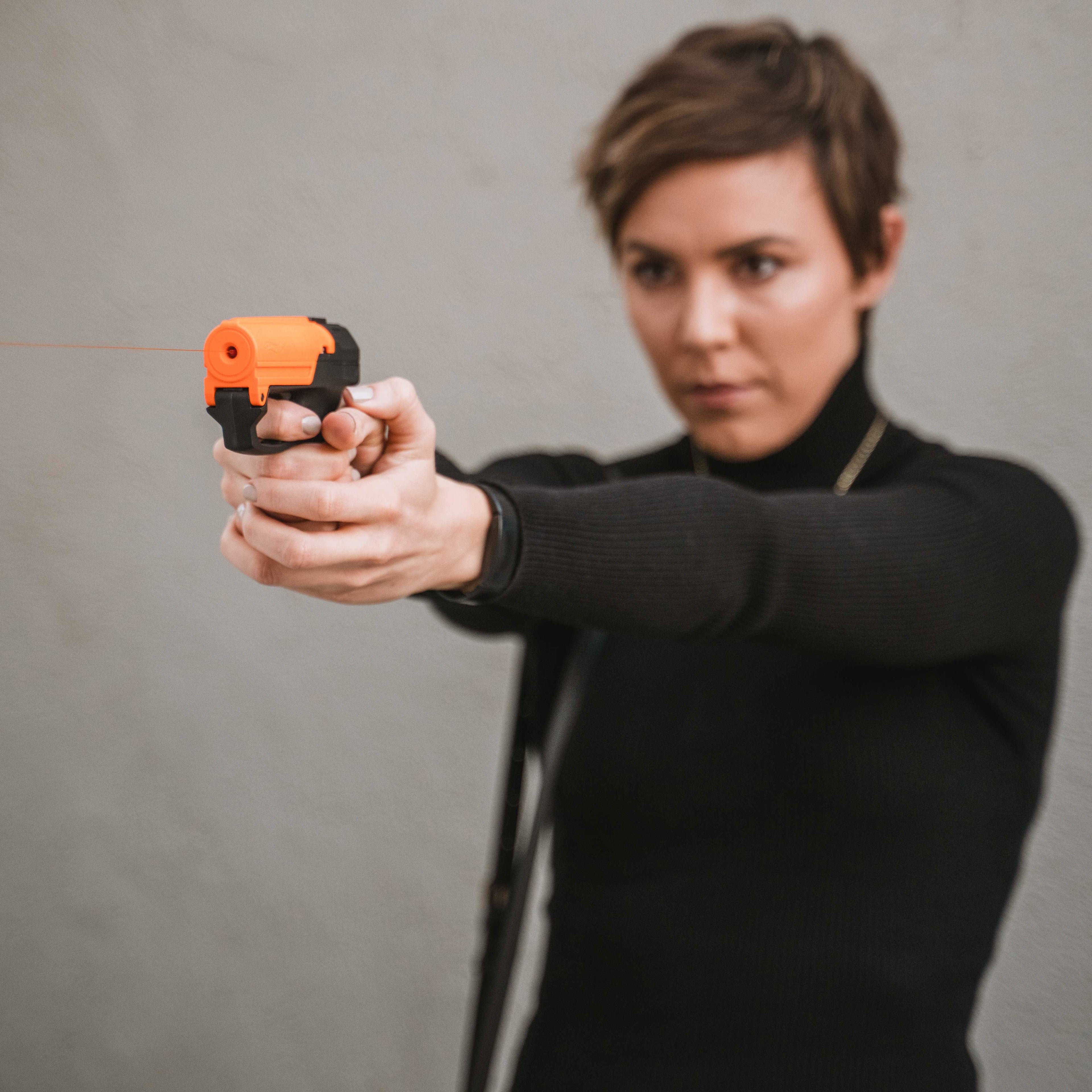 SABRE Aim and Fire Pepper Gel in hand demonstrating grip safety and trigger deployment – easy-aim non-lethal pepper gel pistol for self-defense