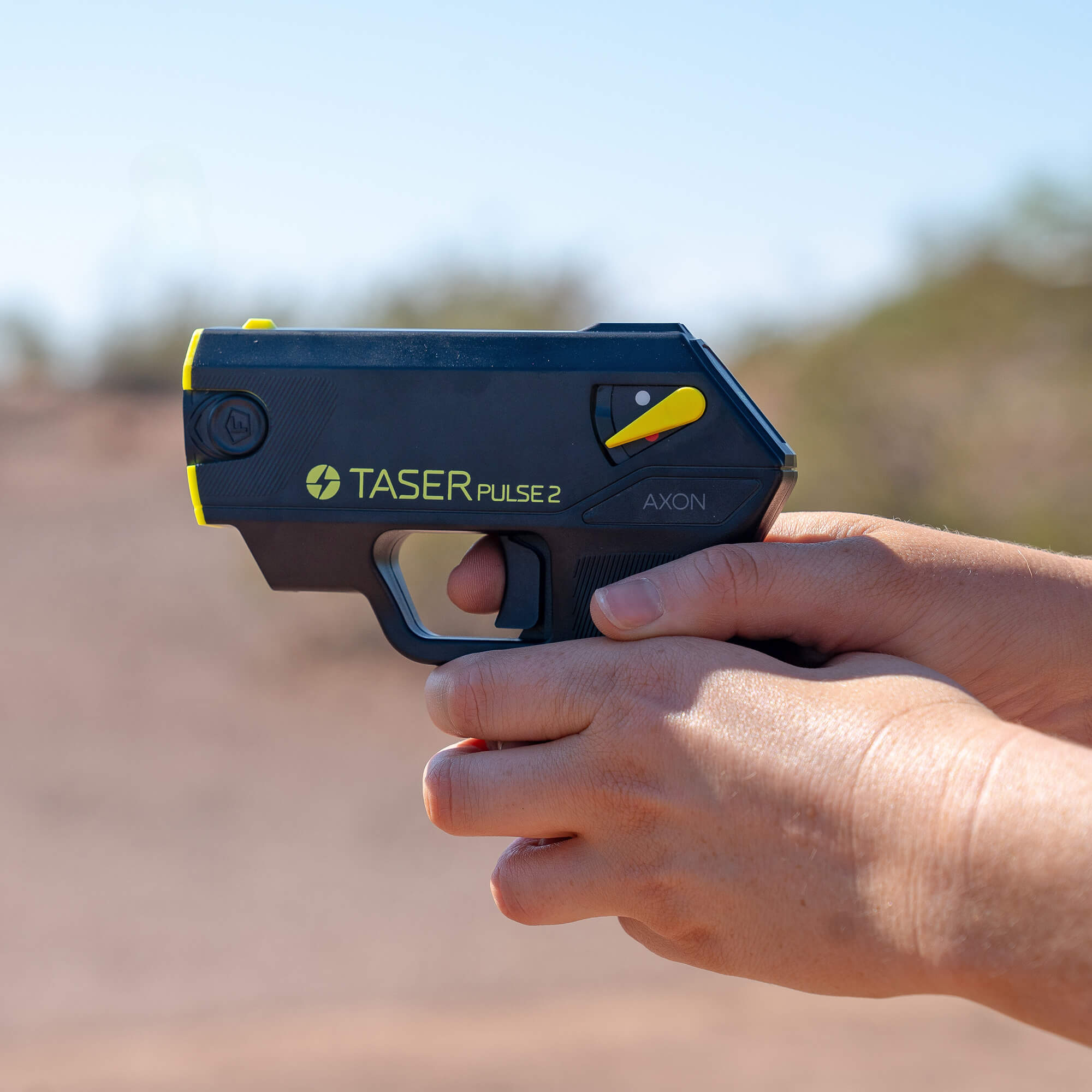 Handheld TASER Pulse 2 stun gun in use, lightweight 8 oz design for everyday carry